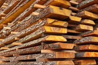 Sawn timber planks stacked at a sawmill — construction materials available at Janjua Timber Merchant, Mirpur AJK